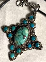 Front view of pendant showing stones and silver detailing