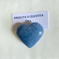 Front view of blue angelite heart with identification card