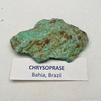 Front view of rough chrysoprase specimen with display label