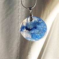 Close-up of blue druzy agate pendant showing crystal cavity