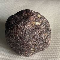 Oblique view of rough garnet showing texture and coloration