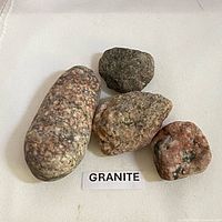 Four granite rocks on white background with label