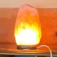 Lamp lit showing warm glow and cord exiting base