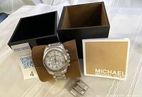 Full lot: watch on pillow, box components, booklet, extra links visible