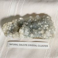 Full view of calcite crystal cluster with label