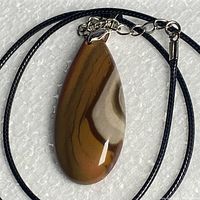 Front view of teardrop jasper pendant on black cord