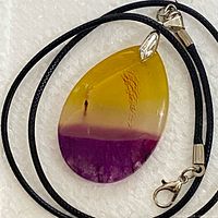 Front view of yellow to purple agate pendant with bail and black cord