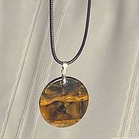 Full view of necklace hanging to show pendant and cord