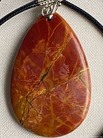 Front view of Picasso Jasper teardrop pendant on cord