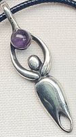 Full view of silver-tone goddess pendant on cord