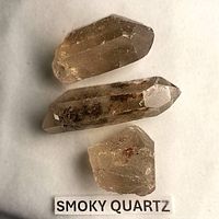 Three smoky quartz pieces on white background