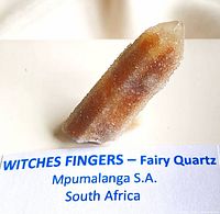 Oblique view of the Fairy Quartz specimen placed upright showing drusy surface and color variations