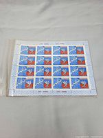 Full front view of the 25-stamp sheet inside sleeve