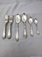 Full set of forks and spoons displayed