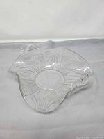 Full view of clear pressed glass dish showing shape and fish handle