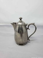 Front profile of pewter creamer showing overall form