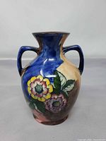 Front view showing floral design, shape and handles