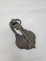 Front view of ornate cast iron door knocker