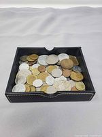 Overall view of tray filled with mixed world coins