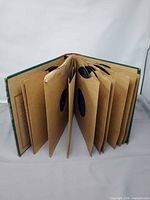 Album binder open showing multiple paper sleeves and records