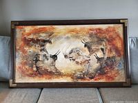 full view of framed painting on sofa backdrop