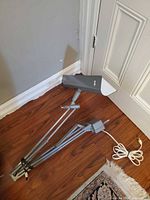 Full view of grey articulated desk lamp with clamp and cord