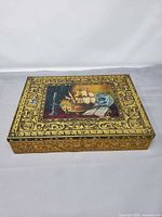 Closed tin showing full lid artwork and border