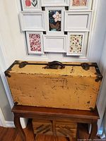 Front view closed suitcase trunk on stand