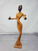Full view of wooden Caribbean dancer sculpture with maracas