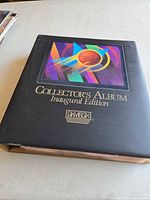 Front cover of black SkyBox Collector’s Album Inaugural Edition