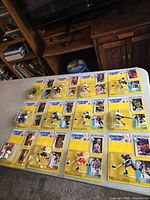 Overall view of 12 sealed Starting Lineup figures on table