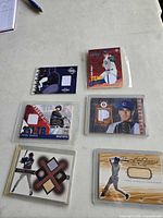 All six memorabilia baseball cards laid out