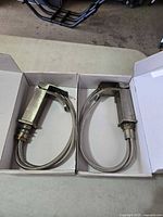 Two matching single-handle faucets in boxes