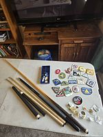 Table with cue shafts, butts, blue tray repair kit, patches and pins