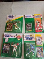 Front view of all four sealed Starting Lineup figures on cards