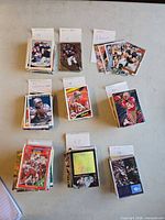 Nine labeled stacks of football cards indicating counts and player names