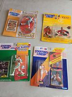 Front view of four sealed Starting Lineup packages