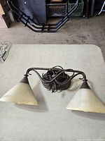 Front view of two-light wall sconce with glass shades
