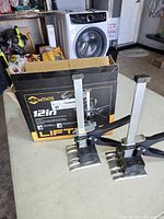 Pair of MTNTE lifter tools beside original box