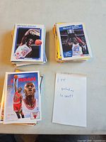 Stacks of Michael Jordan cards with handwritten note showing quantity