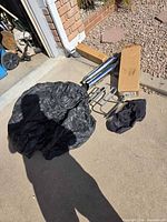 Pipes in box, luggage rack, cover, bag on driveway
