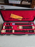 Open case showing two recorders, accessories and red lining