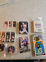 All items in lot displayed including sealed card sets, individual cards, pin and pogs
