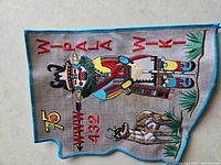 Front of embroidered patch showing design and text