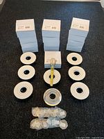 Stacked boxes and loose trims with lenses showing quantity and overall appearance