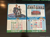 Both calendar posters laid flat showing images and calendar grids
