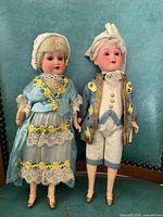 Both Armand Marseille bisque dolls standing side by side