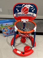 assembled floating hoop with net and two balls in base, box in background