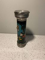 Full view of flashlight standing upright