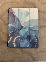Cover closed showing ocean marble exterior design